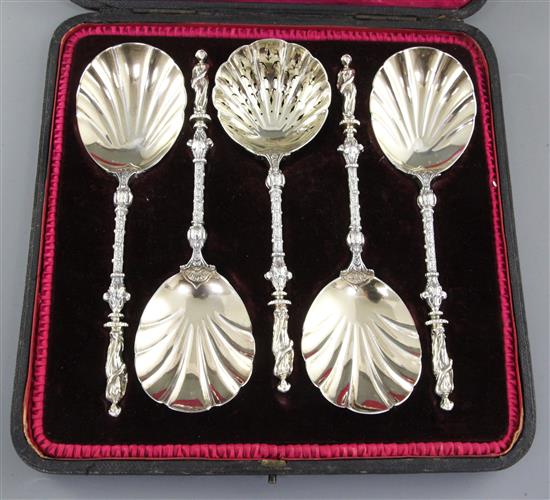 A cased set of four Victorian silver parcel gilt fruit serving spoons and a sugar sifter, spoon 197mm, weight 12.4oz/388 grms.